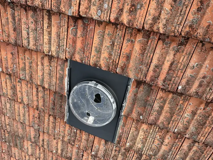 Damaged skylight on a tile roof, traced as the water entry point during a leak inspection.