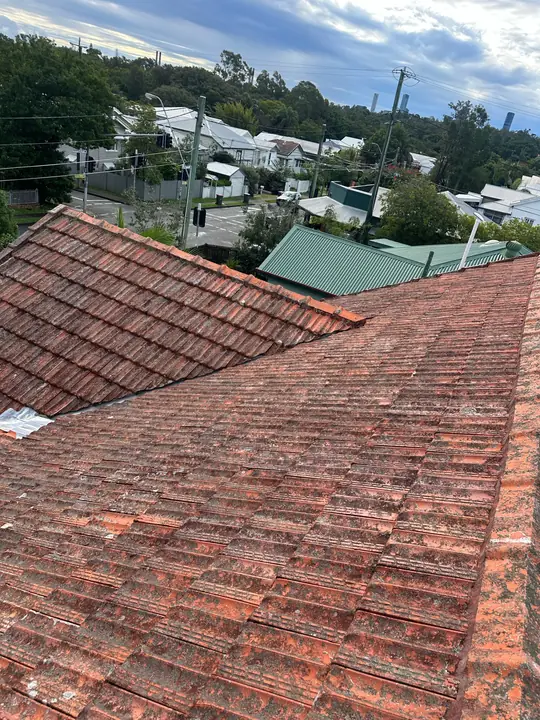 Tile roof valley inspected as the likely source of ongoing water ingress.